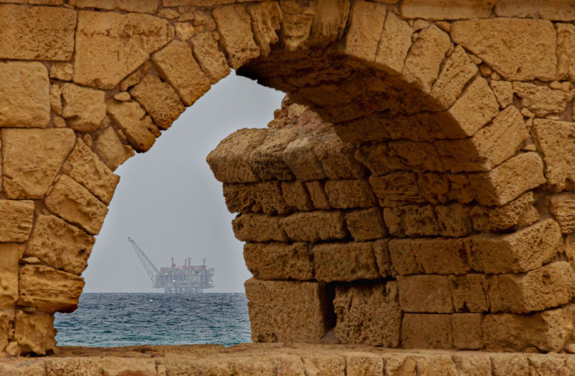The platform in the Leviathan natural gas field in the Mediterranean Sea is pictured through an arcade in the Israeli northern coastal city of Caesarea on Feb. 24, 2022. 