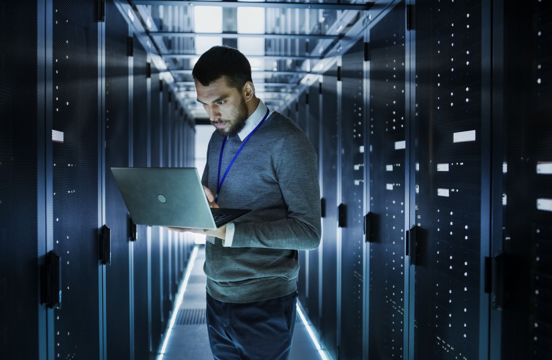 An employee scans information on his laptop. If members of the information technology department are recruited or volunteer to be an espionage agent, they can cause serious damage to their company.
