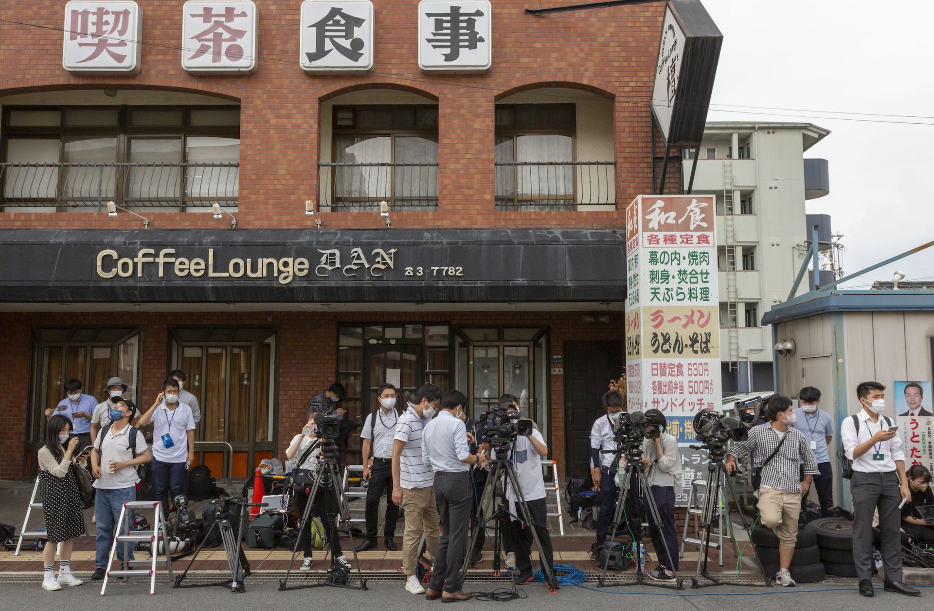 Media members near the hospital where former Japanese Prime Minister Shinzo Abe was transferred after being fatally shot during an election rally July 8, 2022, in Nara, Japan.