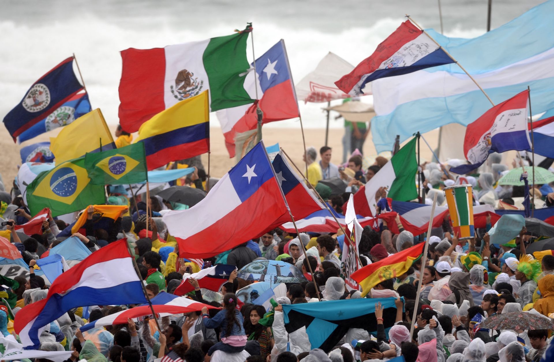 Pilgrims with flags from different countries gather at Copacabana beach in Rio de Janeiro, Brazil, on July 23, 2013, as they wait for the official opening of the Catholic Church's World Youth Day, which will be celebrated with a holy Mass. 