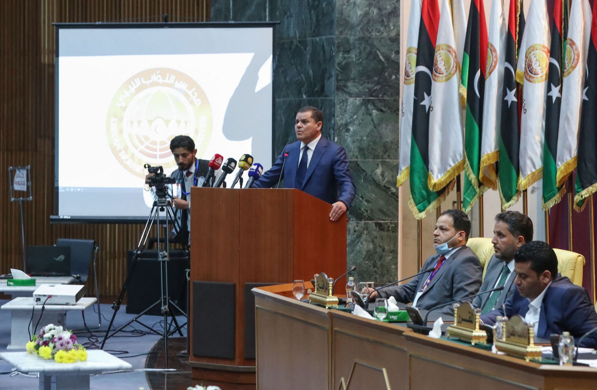 Libyan Prime Minister-designate Abdul Hamid Dbeibah addresses lawmakers during the first reunited parliamentarian session on March 9, 2021, in the coastal city of Sirte, east of the Libyan capital of Tripoli.