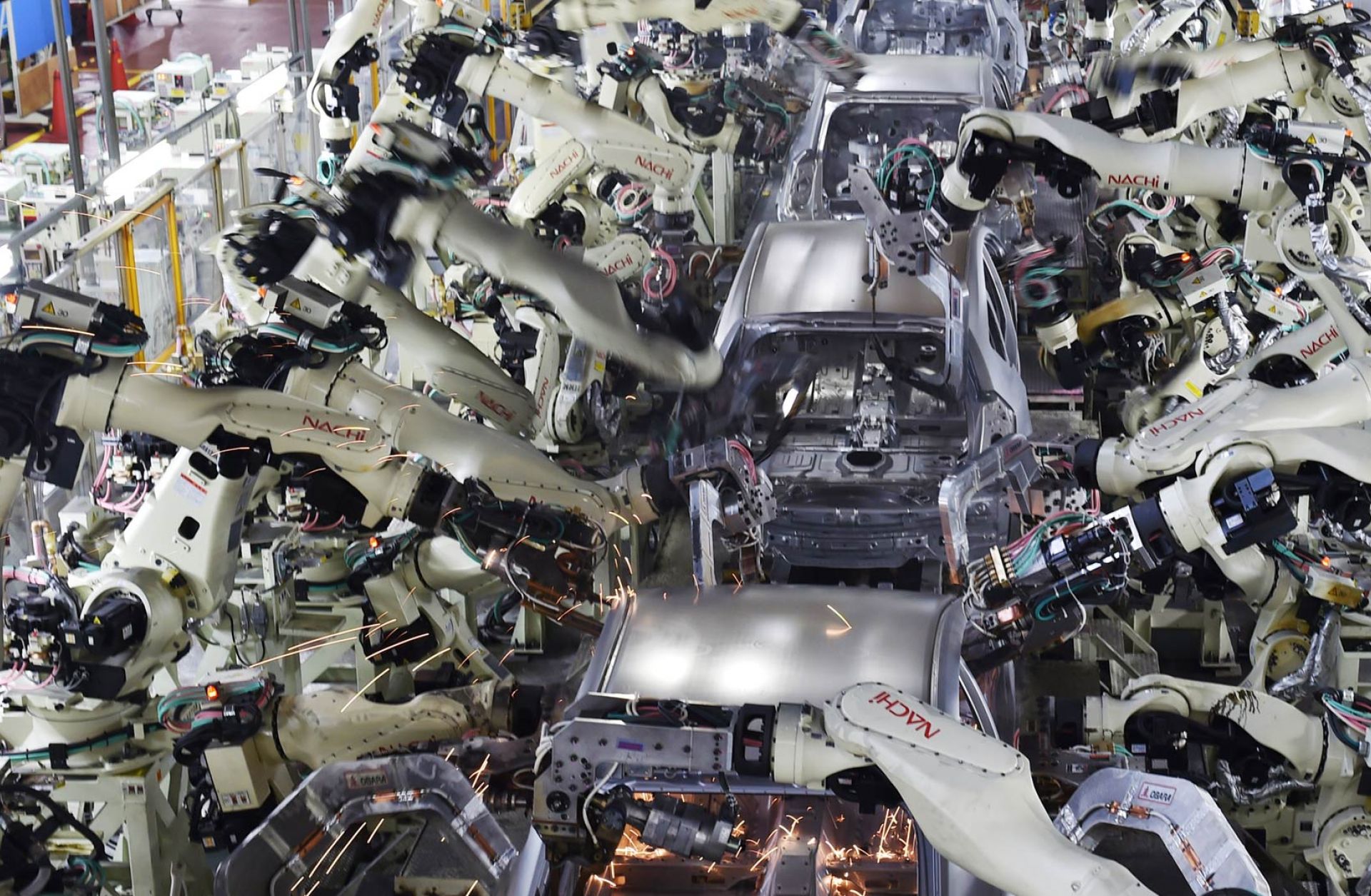 Automated welding machine robots assemble automobile bodies at Toyota Motor's Tsutsumi plant in Toyota, Japan.