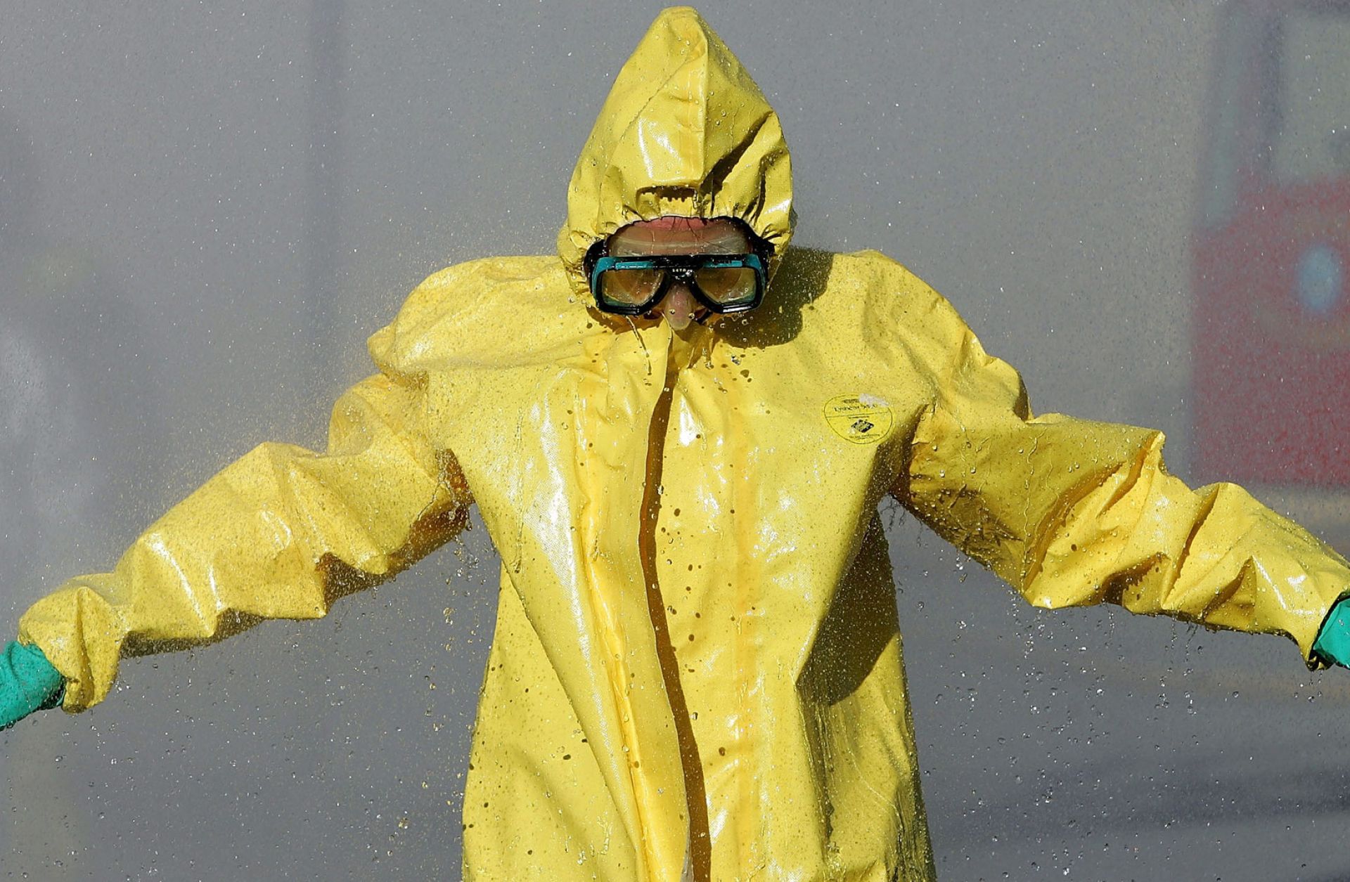 A man in a hazardous materials suit goes through a decontamination shower during a WMD training workshop in California.