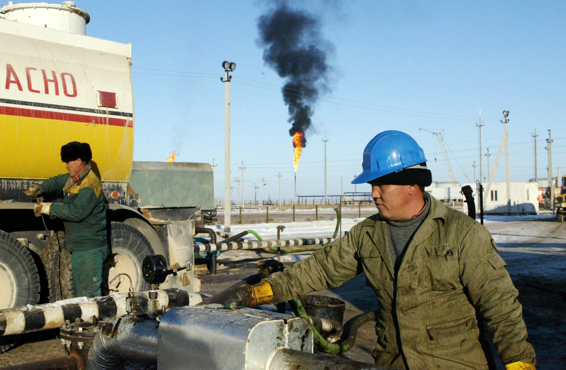A Kazakh worker unloads oil at a terminal. 