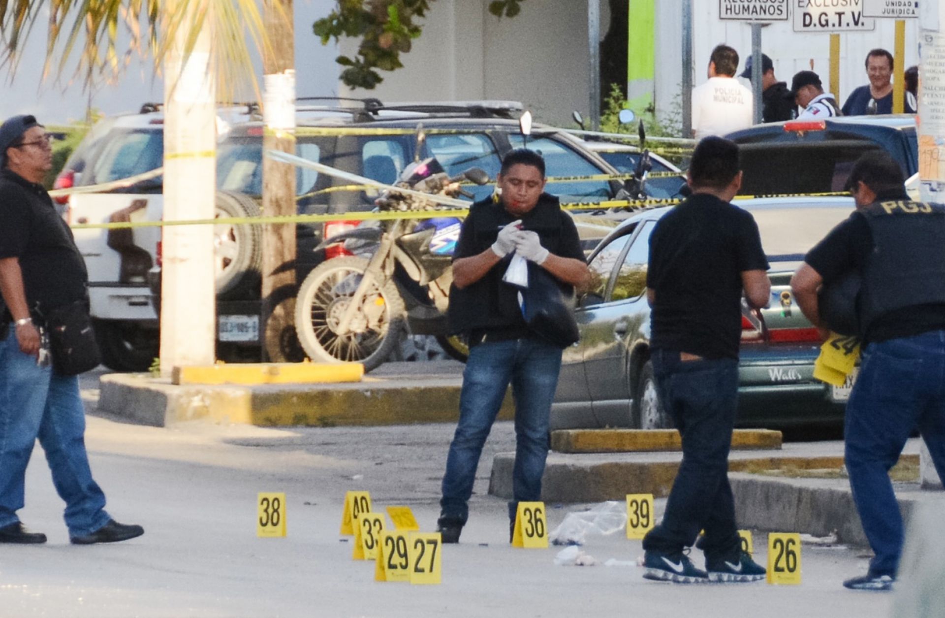 Investigators work a crime scene in Cancun, Mexico, where a gunfight erupted on Jan. 17.