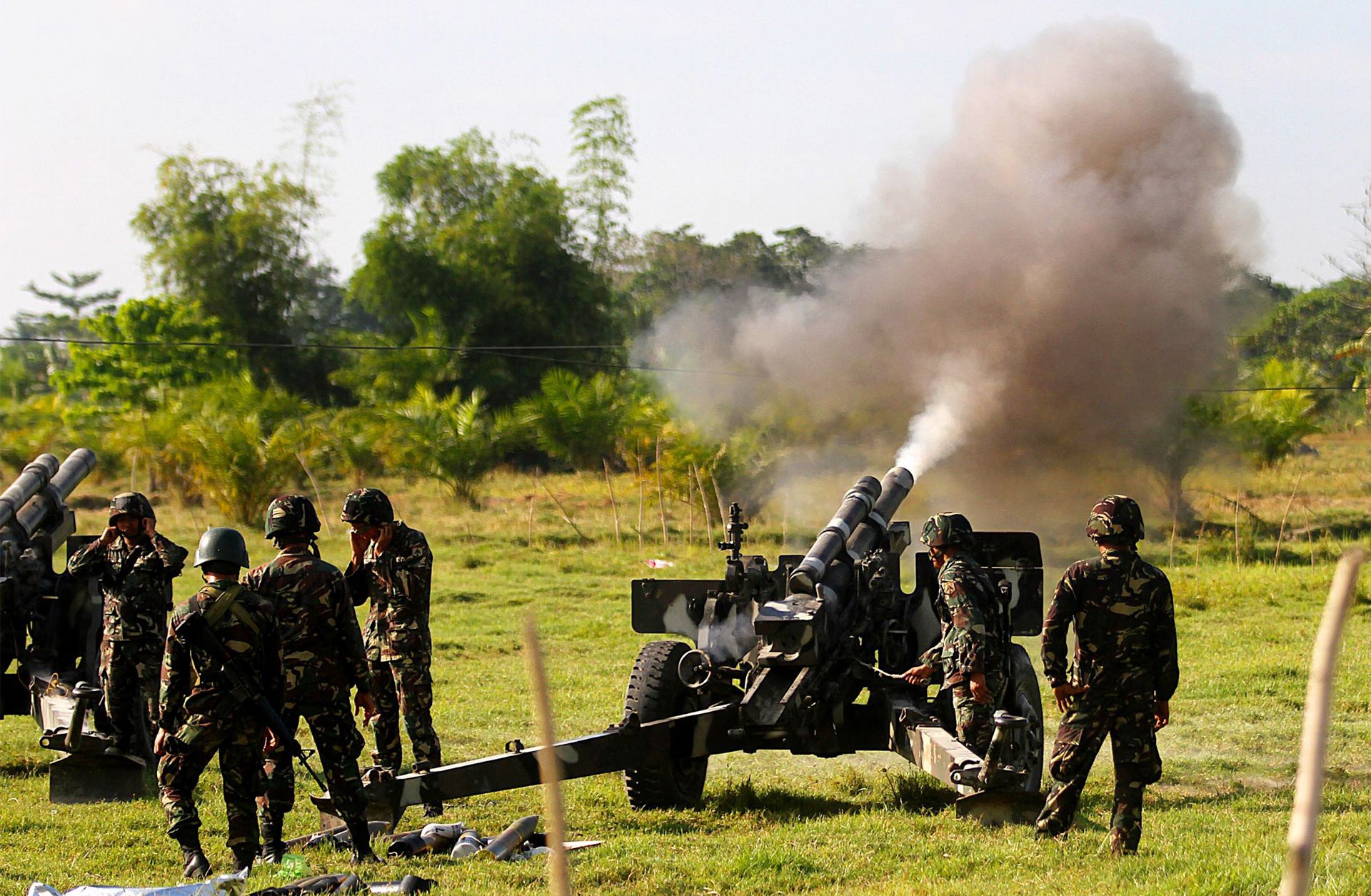 Government forces of the Sixth Infantry Division fire artillery in Maguindanao in the southern Philippines.