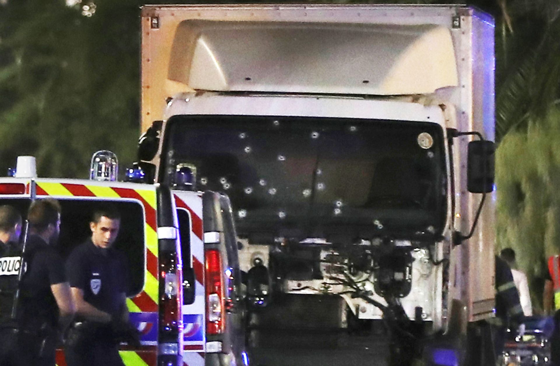 Police officers stand near the truck used to plow through a crowd in Nice, France, on July 14. Based on the rampage's success, the Islamic State's Rumiyah magazine has encouraged the group's followers to conduct more attacks using large, paneled trucks.
