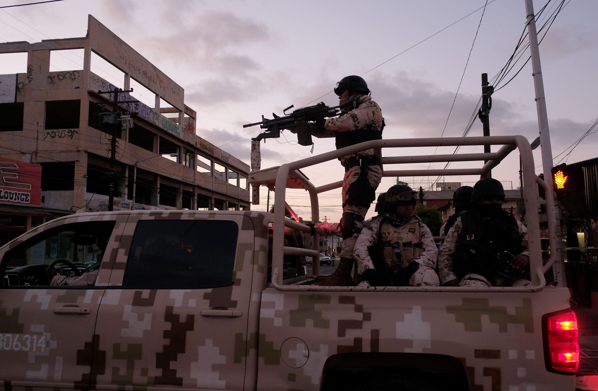 Mexican Soldiers leave the scene of a crime where a man was killed by gun fire in downtown Tijuana.