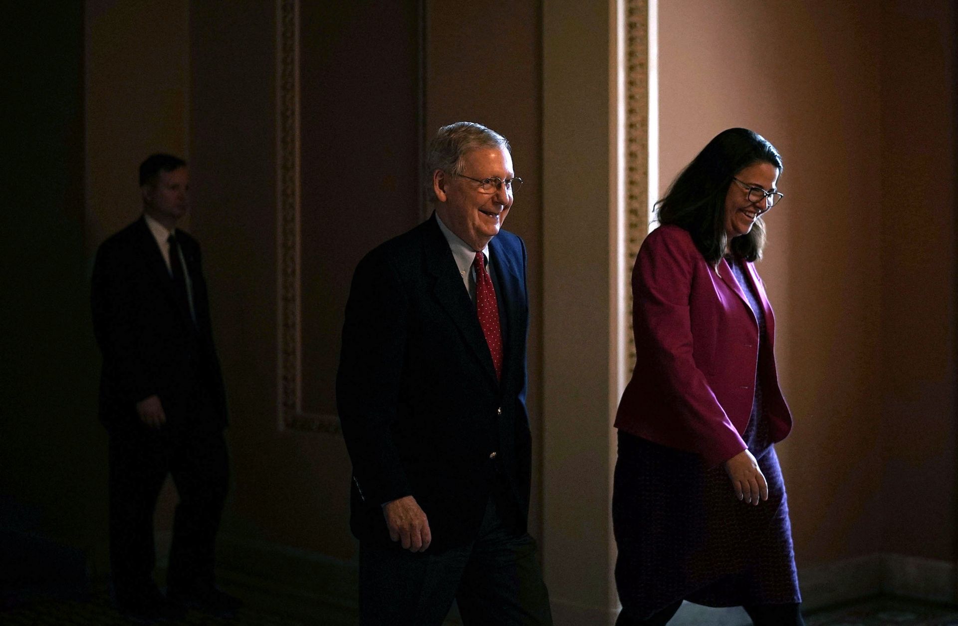 U.S. Senate Majority Leader Mitch McConnell, left, and an aide walk toward the Senate chamber in the U.S. Capitol on Feb. 12, 2018.