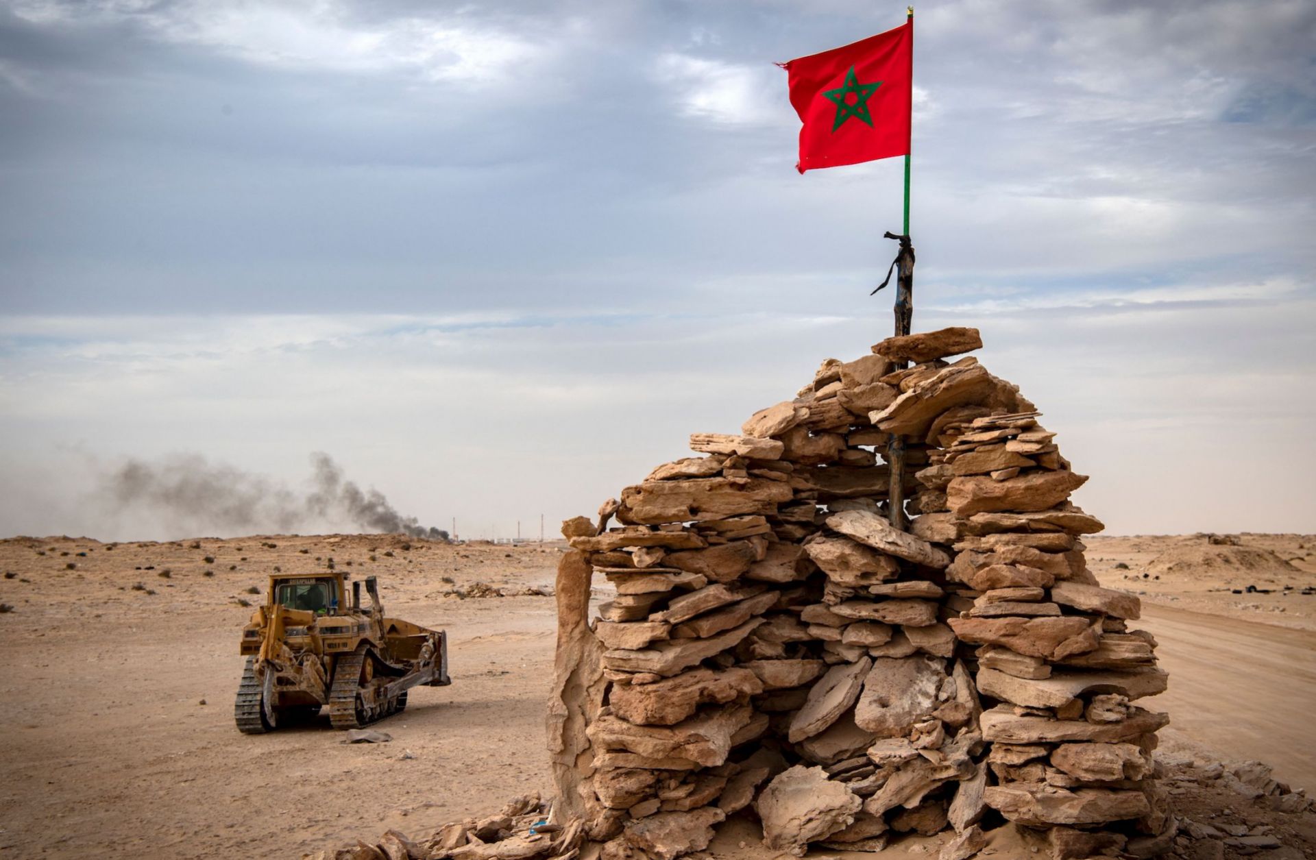 A bulldozer passes by a hilltop manned by Moroccan soldiers in Western Sahara on Nov. 23, 2020.