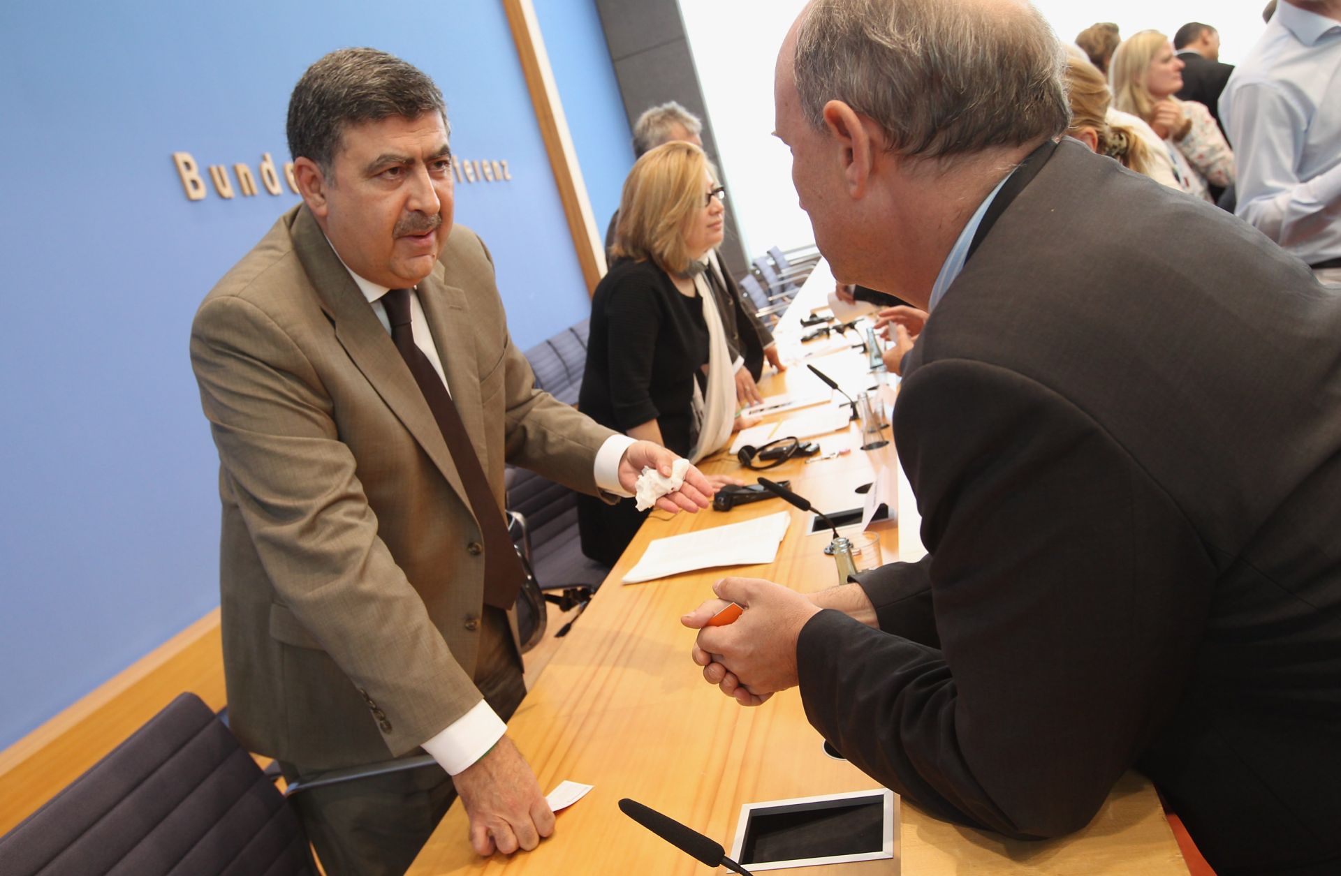 Murhaf Jouejati (L) and Afra Jalabi, both of the Syrian National Council, speak to journalists following a press conference.