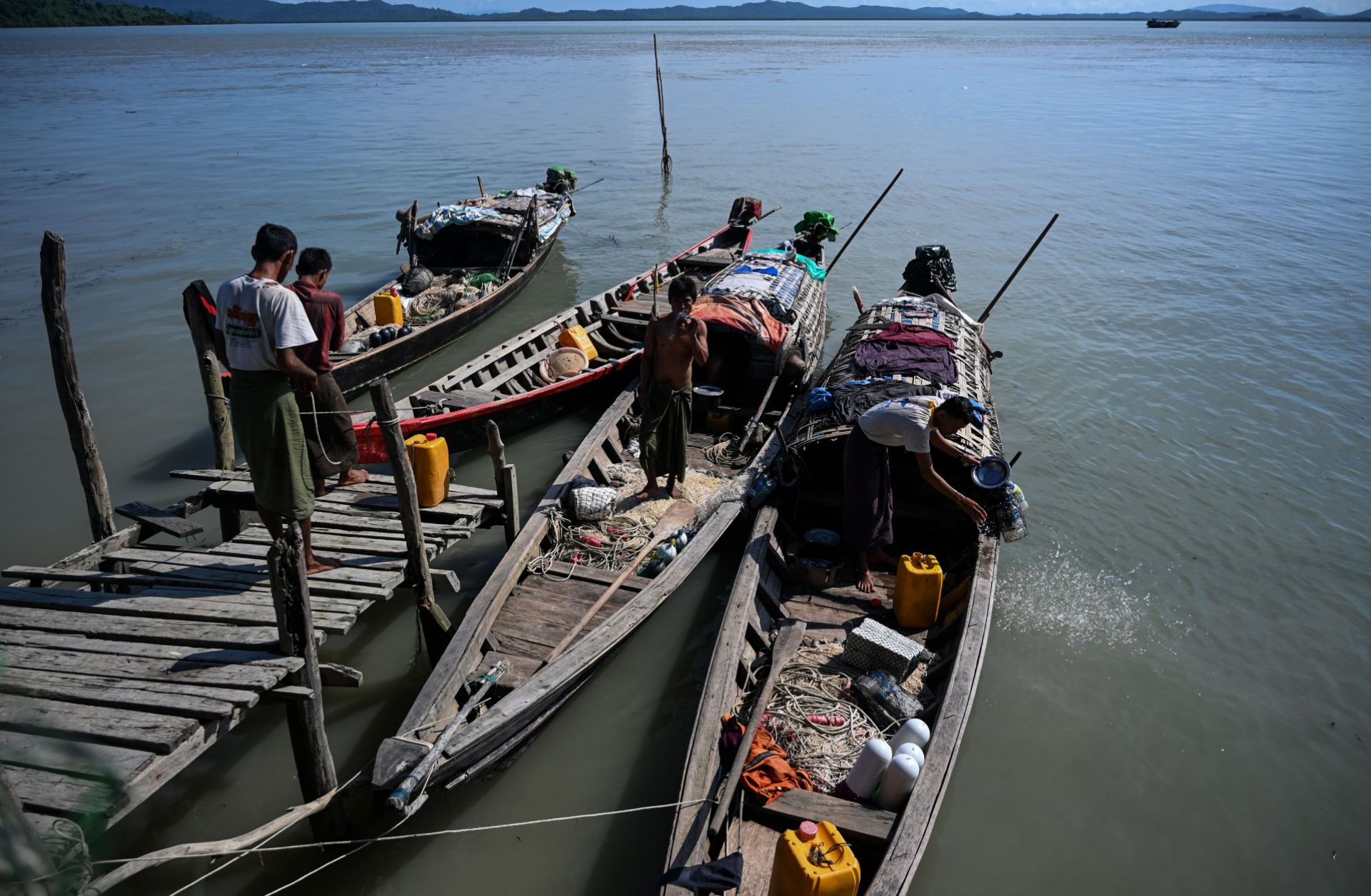 This photo taken on Oct. 2, 2019, shows fishermen boarding their boats at a small jetty on Made Island off Kyaukphyu in Myanmar's Rakhine state.