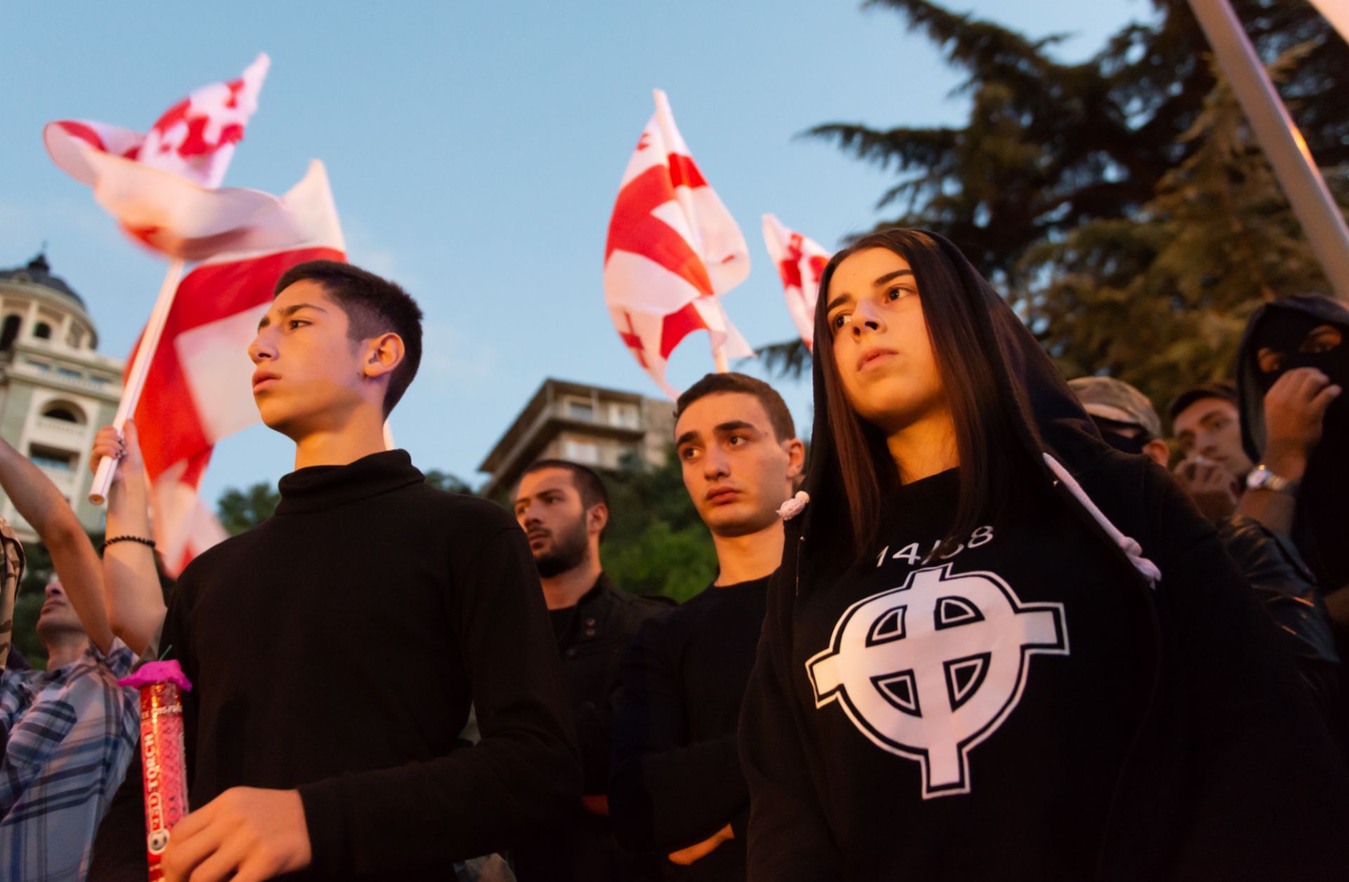 A young Georgian, right, wears a T-shirt with the Stormfront logo and the number 14/88 during a September 2016 rally. The number 14 denotes David Lane’s 14-word white supremacist mantra while 88, as the eighth letter of the alphabet, signifies HH, which stands for Heil Hitler.