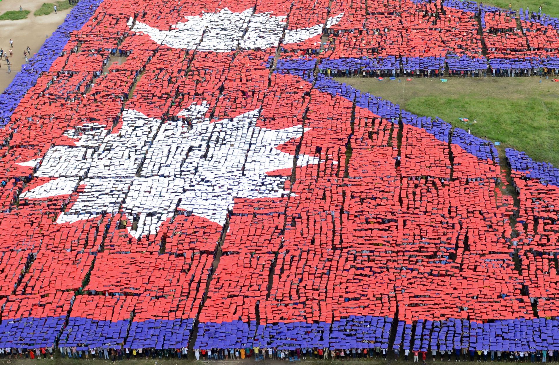 An aerial view of the Nepalese national flag formed by more than 35,000 people Aug. 23, 2014, in central Kathmandu, Nepal.