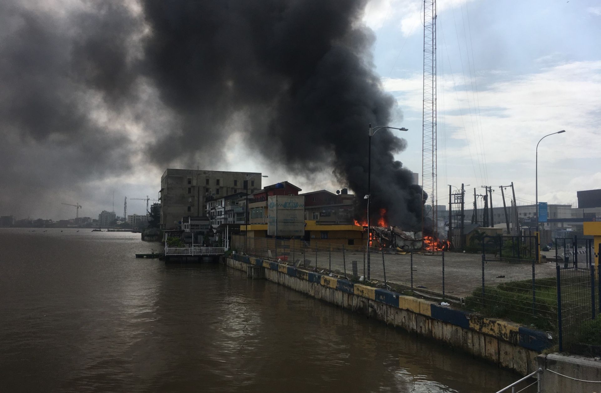 A building remains on fire in Lekki, Nigeria, on Oct. 21, 2020, after #EndSARS protests escalated into violent clashes with police the previous night. 