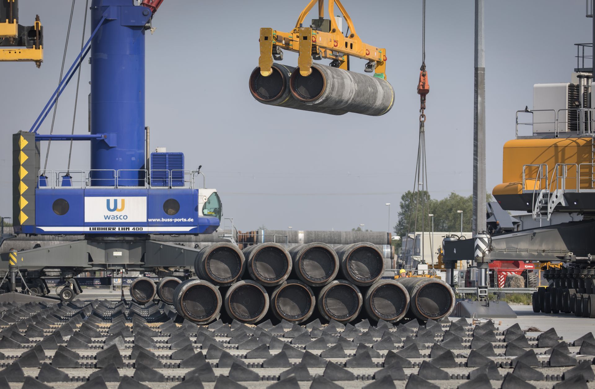 A crane moves Nord Stream 2 pipes at a port near Sassnitz, Germany, on June 5, 2019. A crane moves Nord Stream 2 pipes at a port near Sassnitz, Germany, on June 5, 2019.