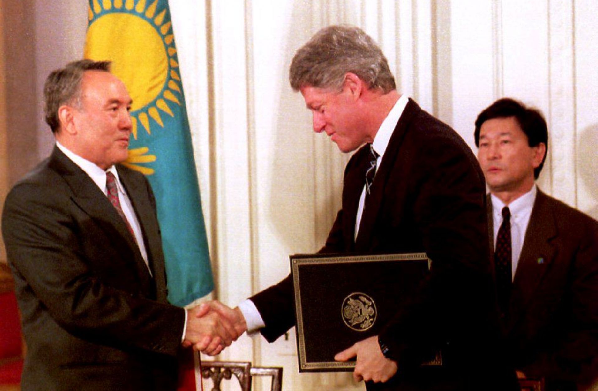 U.S. President Bill Clinton and Kazakh President Nursultan Nazarbayev shake hands at the White House on Feb. 14, 1994, after Nazarbayev presented Clinton with Kazakhstan's accession to the Nuclear Nonproliferation Treaty.