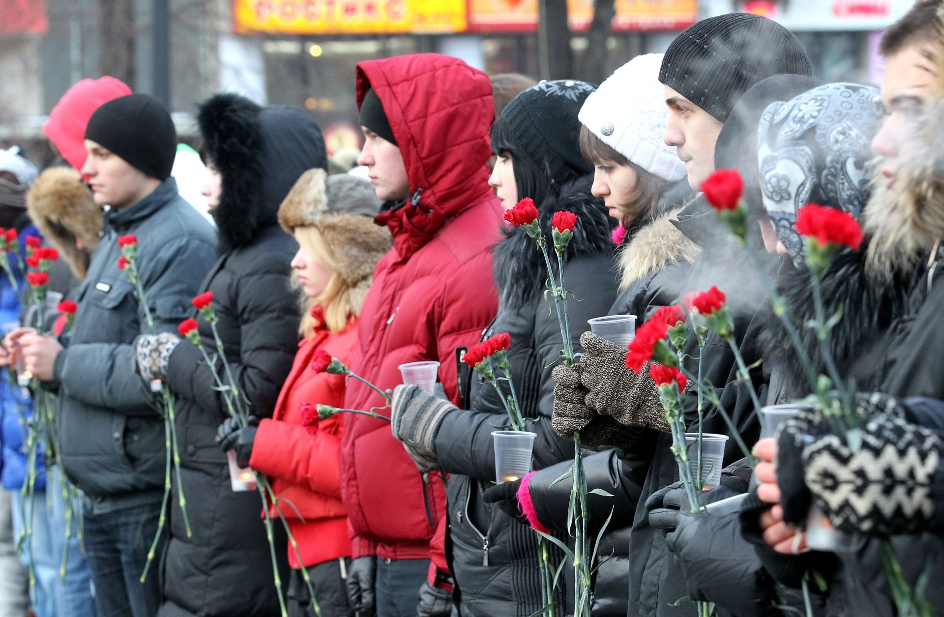 People hold flowers in central Moscow.