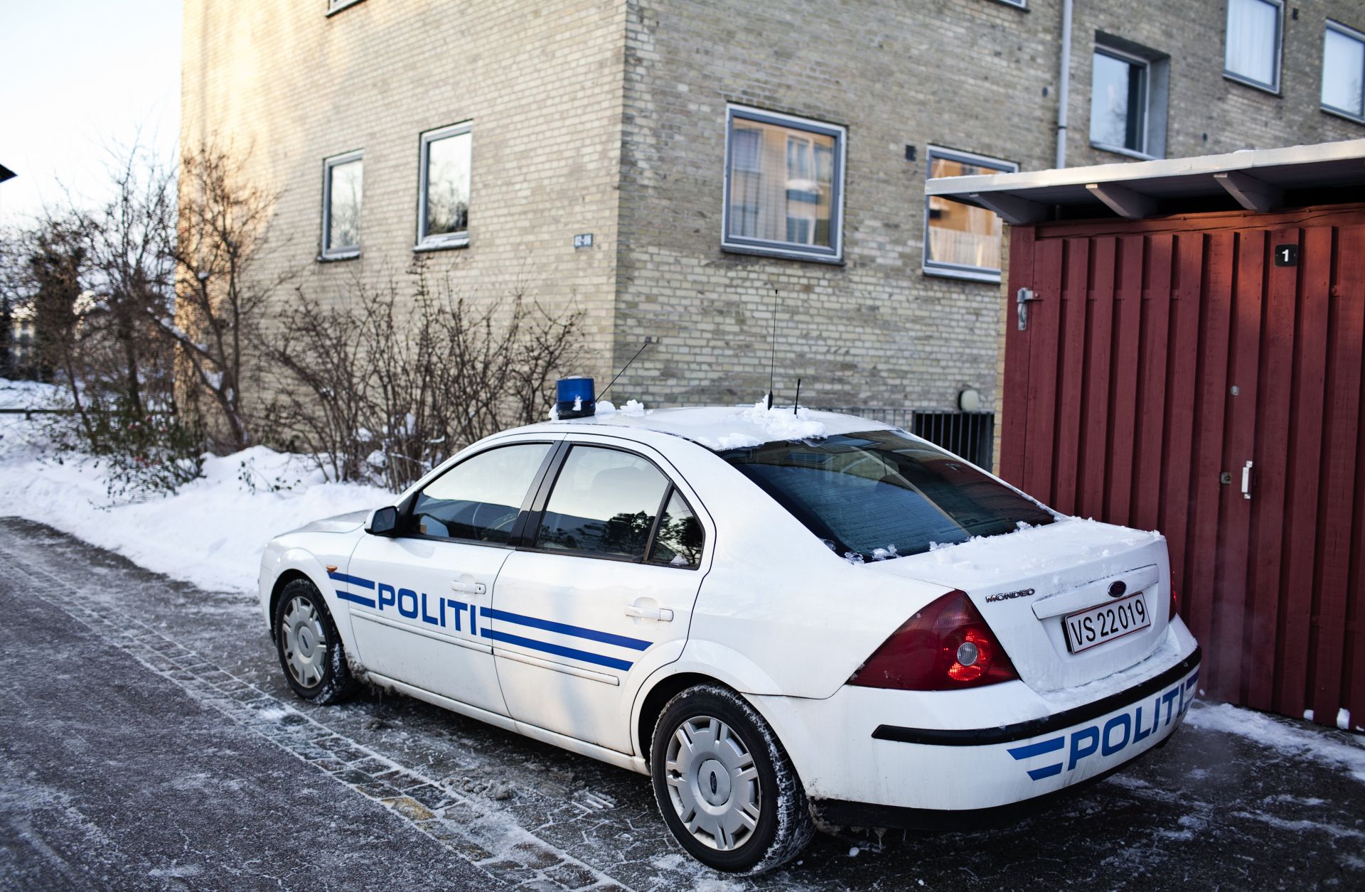 A police car is parked outside of the place where Islamist militants were arrested, suspected of a plot to massacre staff at a Danish newspaper.