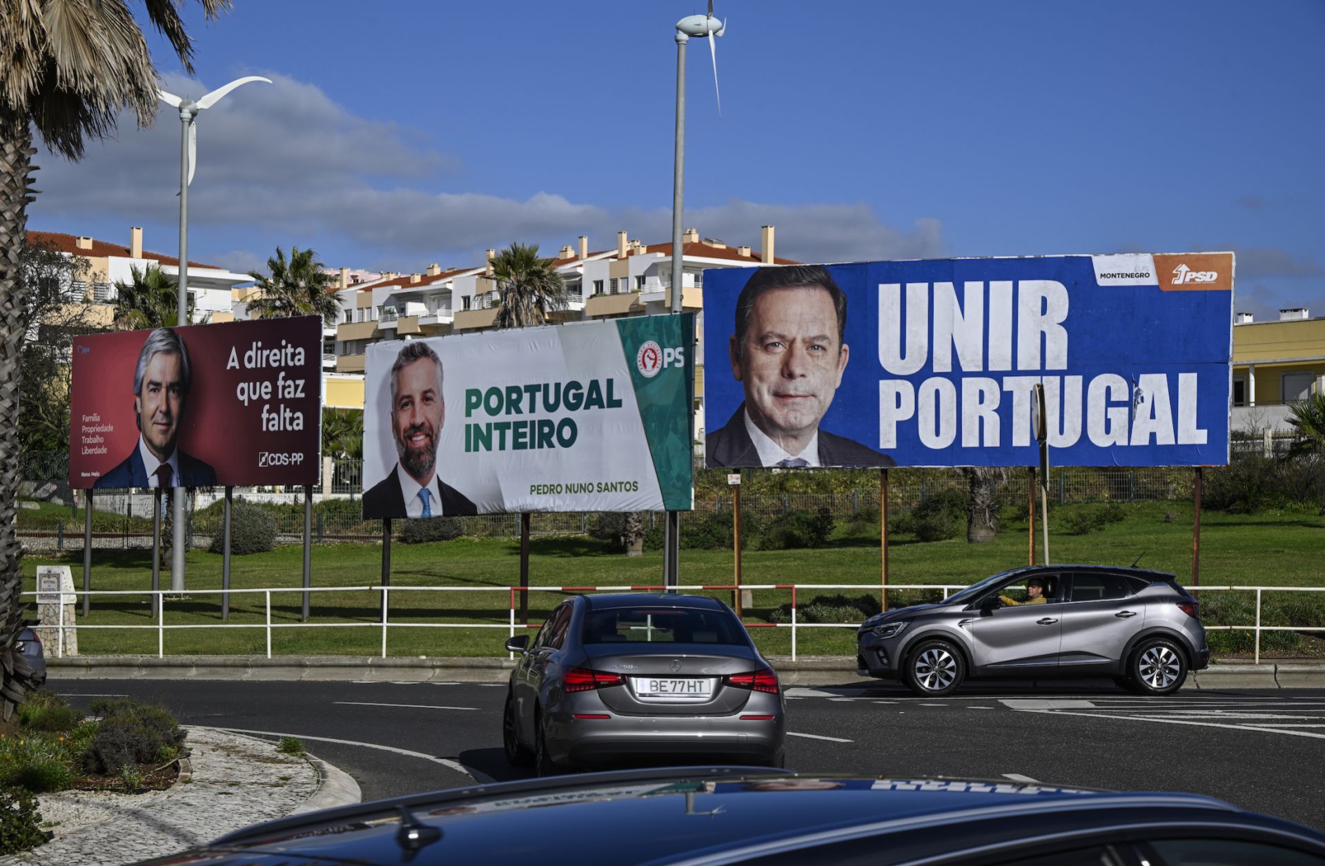 A photo taken on Jan. 20, 2024, shows cars driving by campaign billboard posters in Sao Pedro do Estoril, Portugal, ahead of the country's March 10 parliamentary elections. 