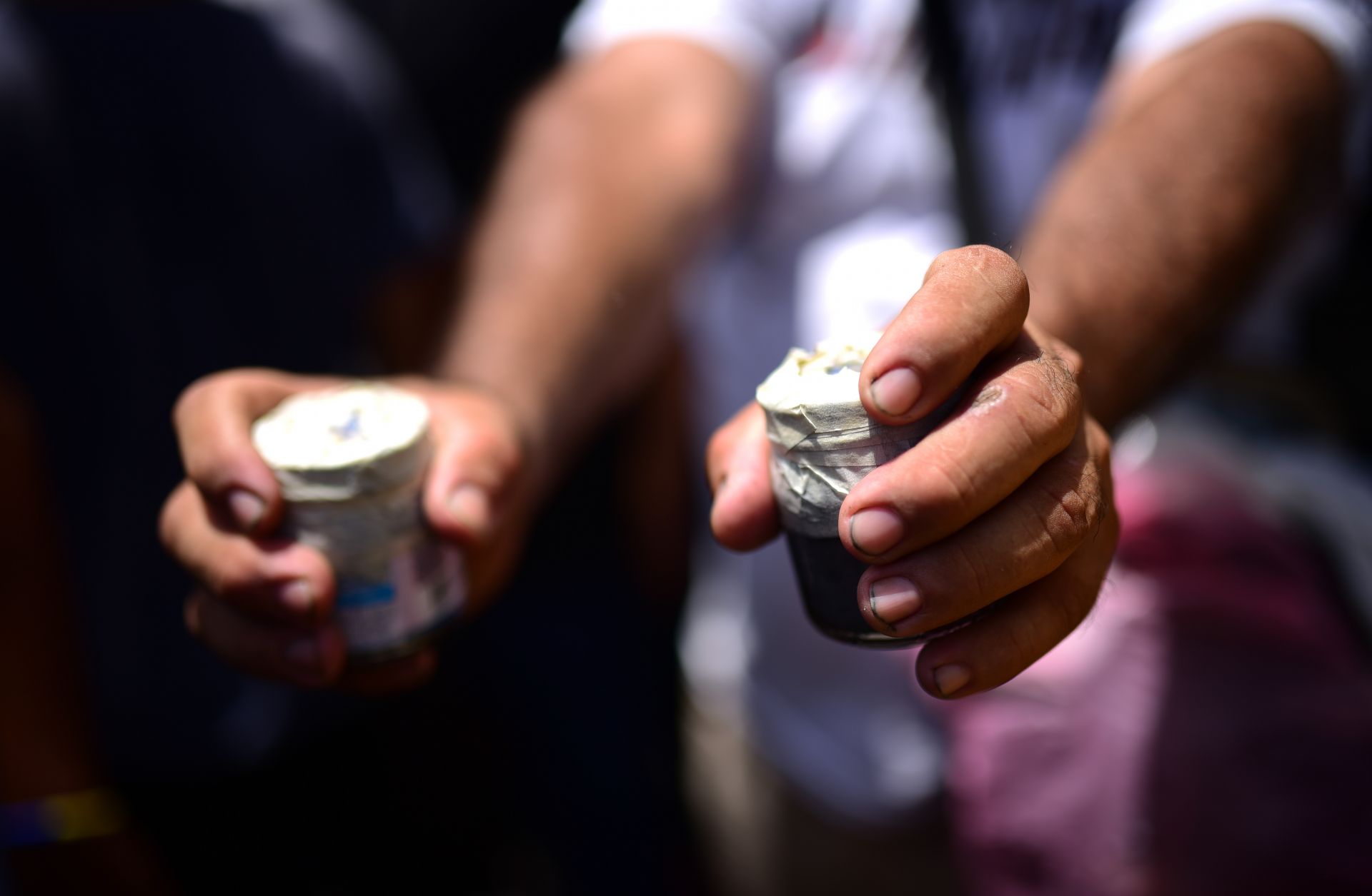 A protestor in Nicaragua shows off two homemade bombs.
