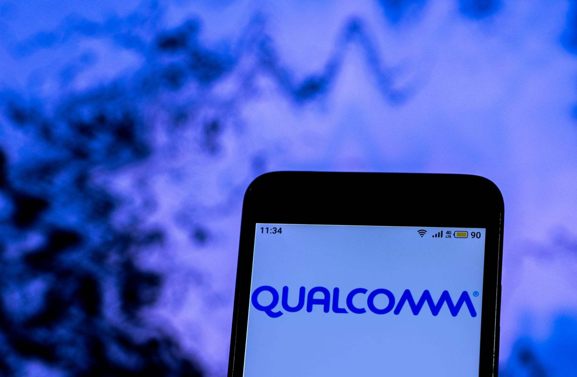 A smartphone displays Qualcomm's company logo.