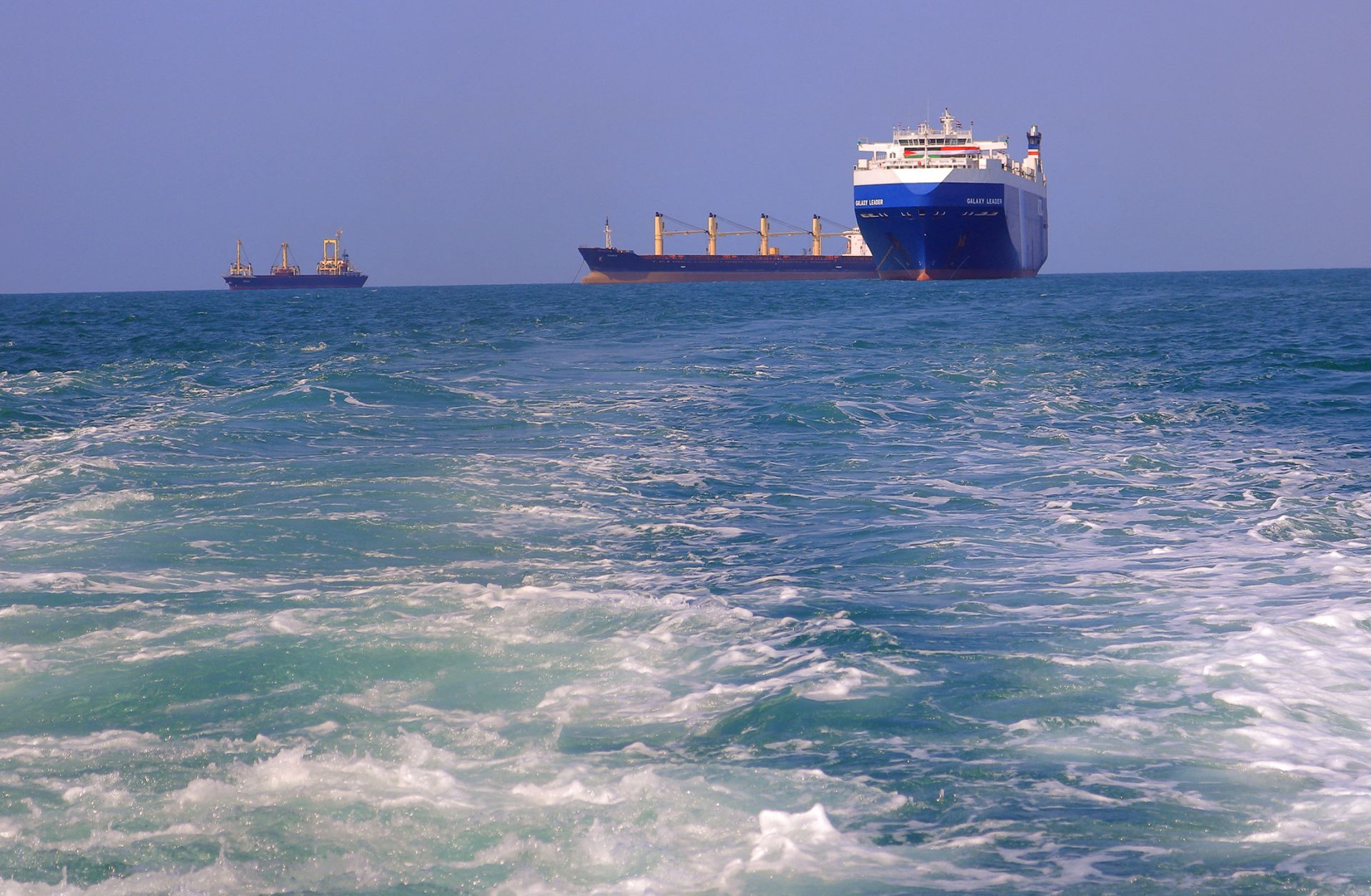 A picture taken on Nov. 22, 2023, shows the Galaxy Leader cargo ship (right), seized by Houthi fighters two days earlier, approaching a port in the Red Sea off Yemen's province of Hodeida. 