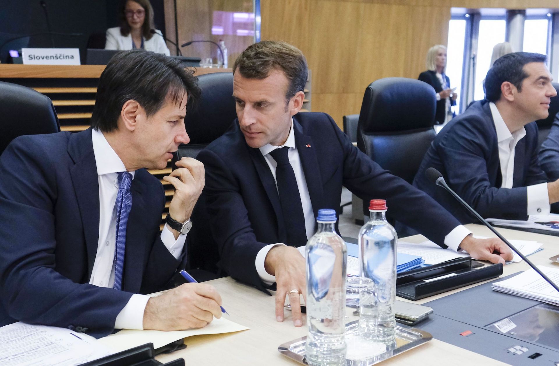 Italian Prime Minister Giuseppe Conte, left, speaks with French President Emmanuel Macron during a summit on migration issues at EU headquarters in Brussels on June 24.