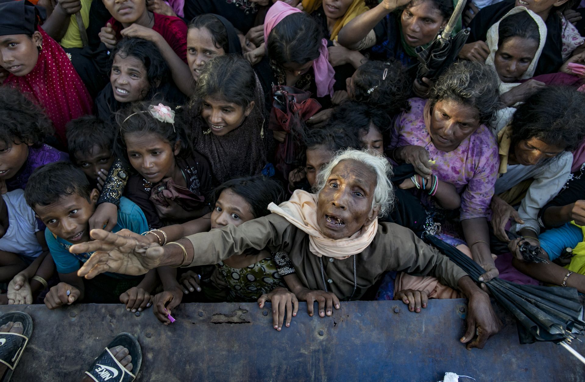 A throng of Rohingya refugees recently arrived in Bangladesh await aid donations.