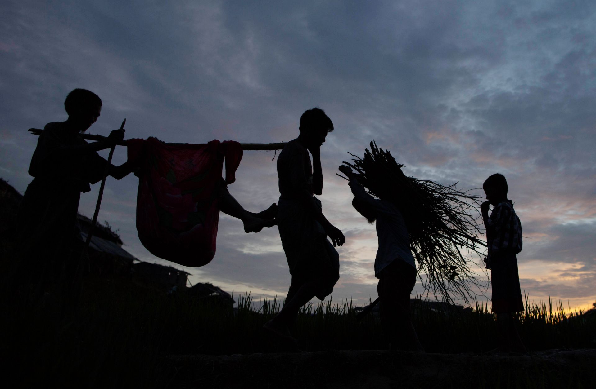 Rohingya refugees walk through a camp in Bangladesh after arriving from Myanmar.