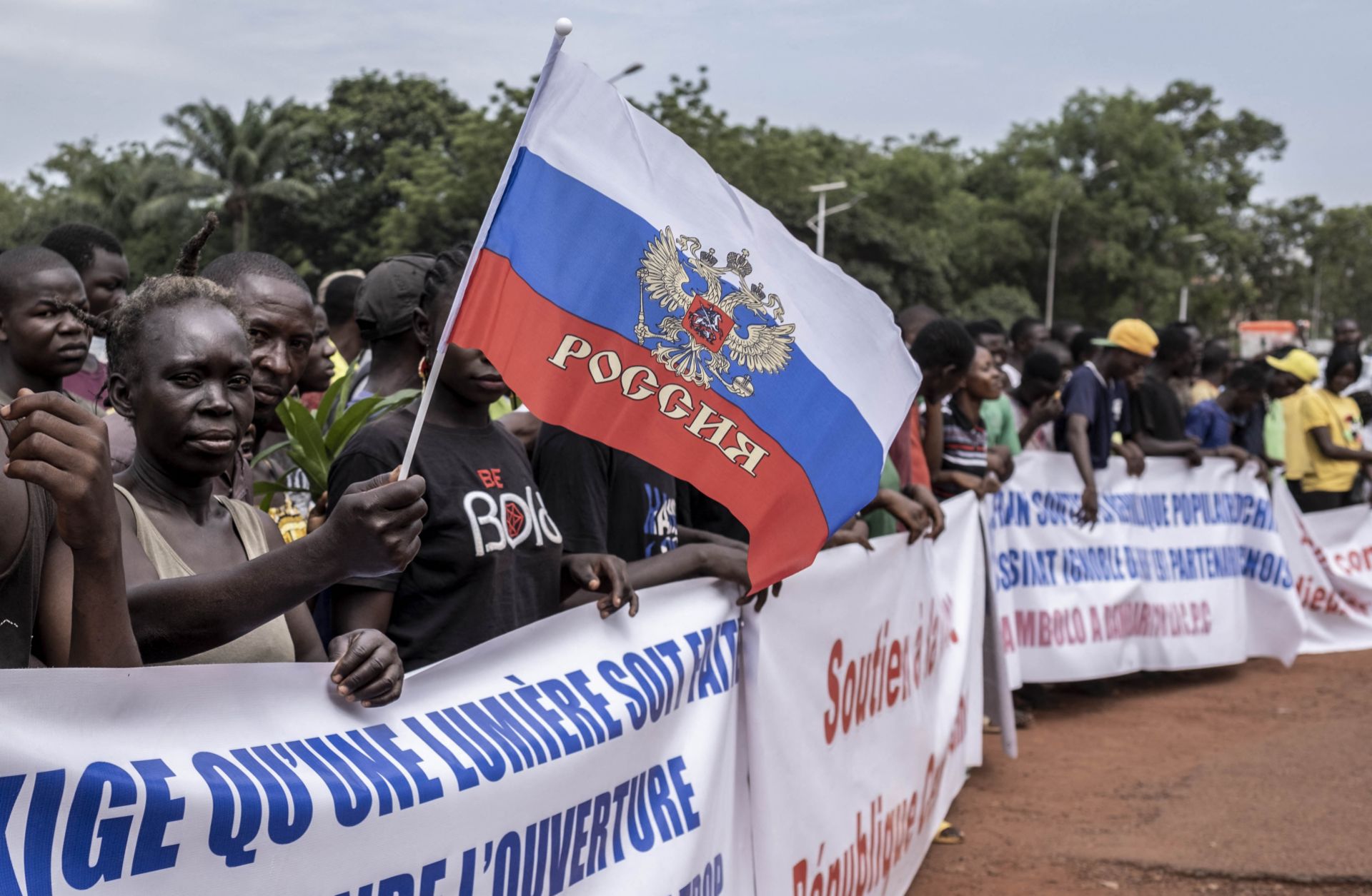 A demonstrator holds a Russian flag in Bangui, the Central African Republic during a march in support of Russia and China's presence in the country on March 22, 2023.