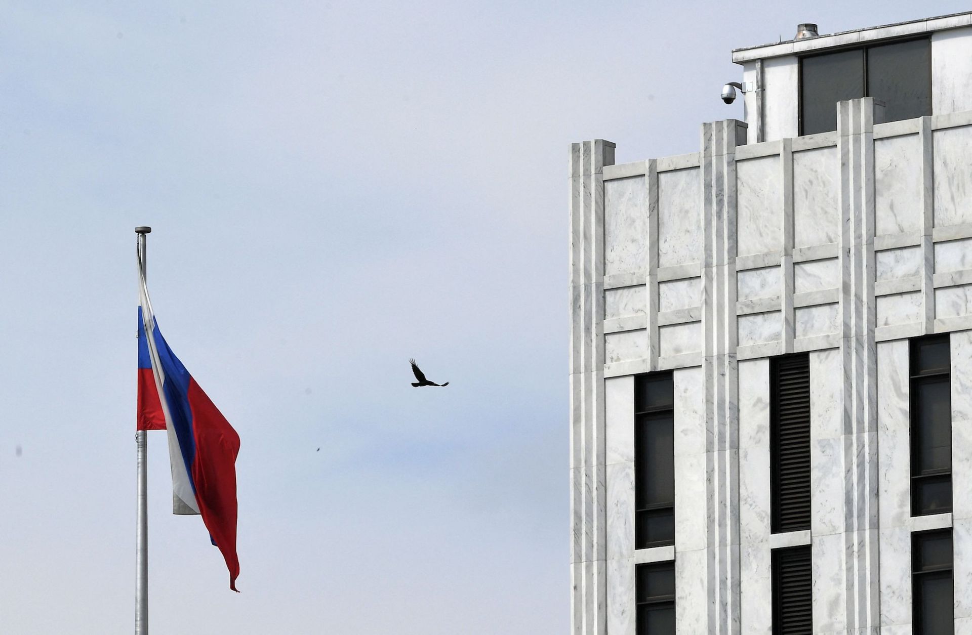 A bird flies past the flag outside the Russian embassy in Washington D.C. on April 15, 2021. A bird flies past the flag outside the Russian embassy in Washington D.C. on April 15, 2021.