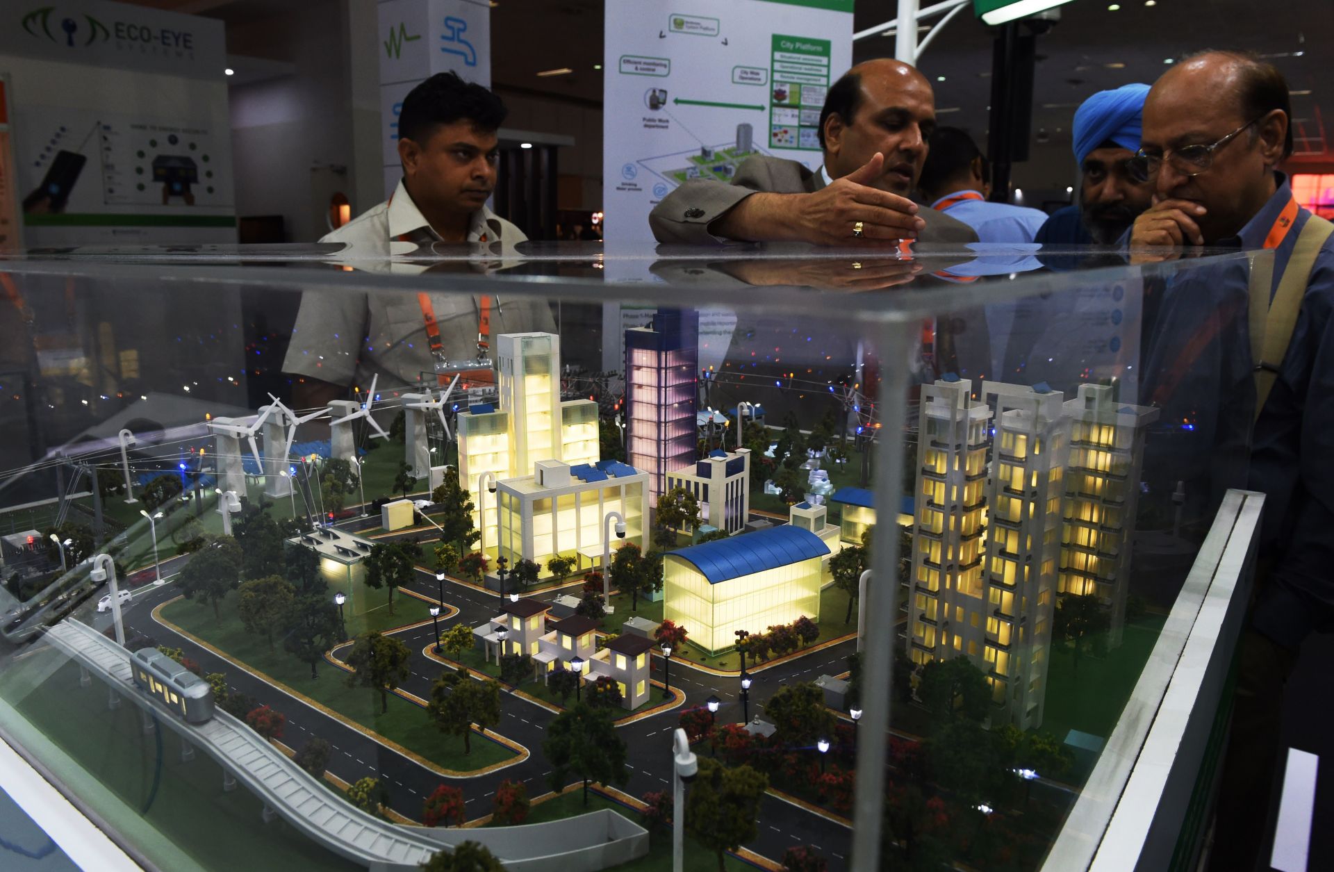 Attendees at an expo in New Delhi, India, take in a model of a "smart city," an urban area wired with connected information and communication technology systems. 