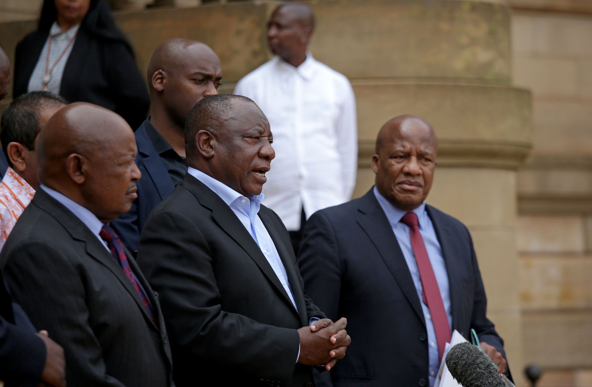 South African President Cyril Ramaphosa (center) addresses the media in Pretoria after concluding a meeting with various business and political leaders on matters relating to the COVID-19 outbreak on March 22, 2020. 