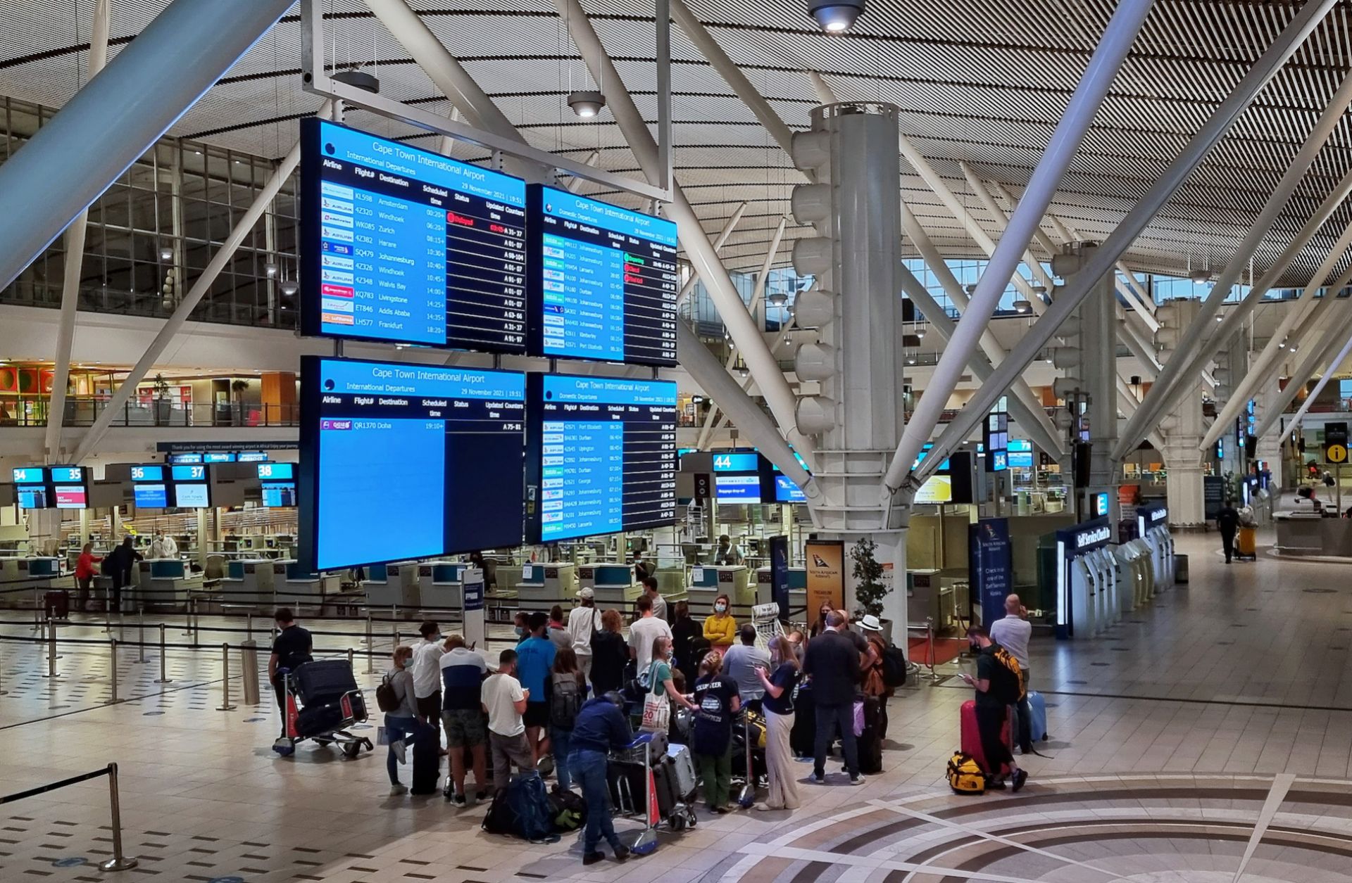 Passengers wait to check in for one of the last international flights out of Cape Town, South Africa, after countries began imposing travel bans to contain the spread of the new Omicron COVID-19 variant on Nov. 29, 2021. 
