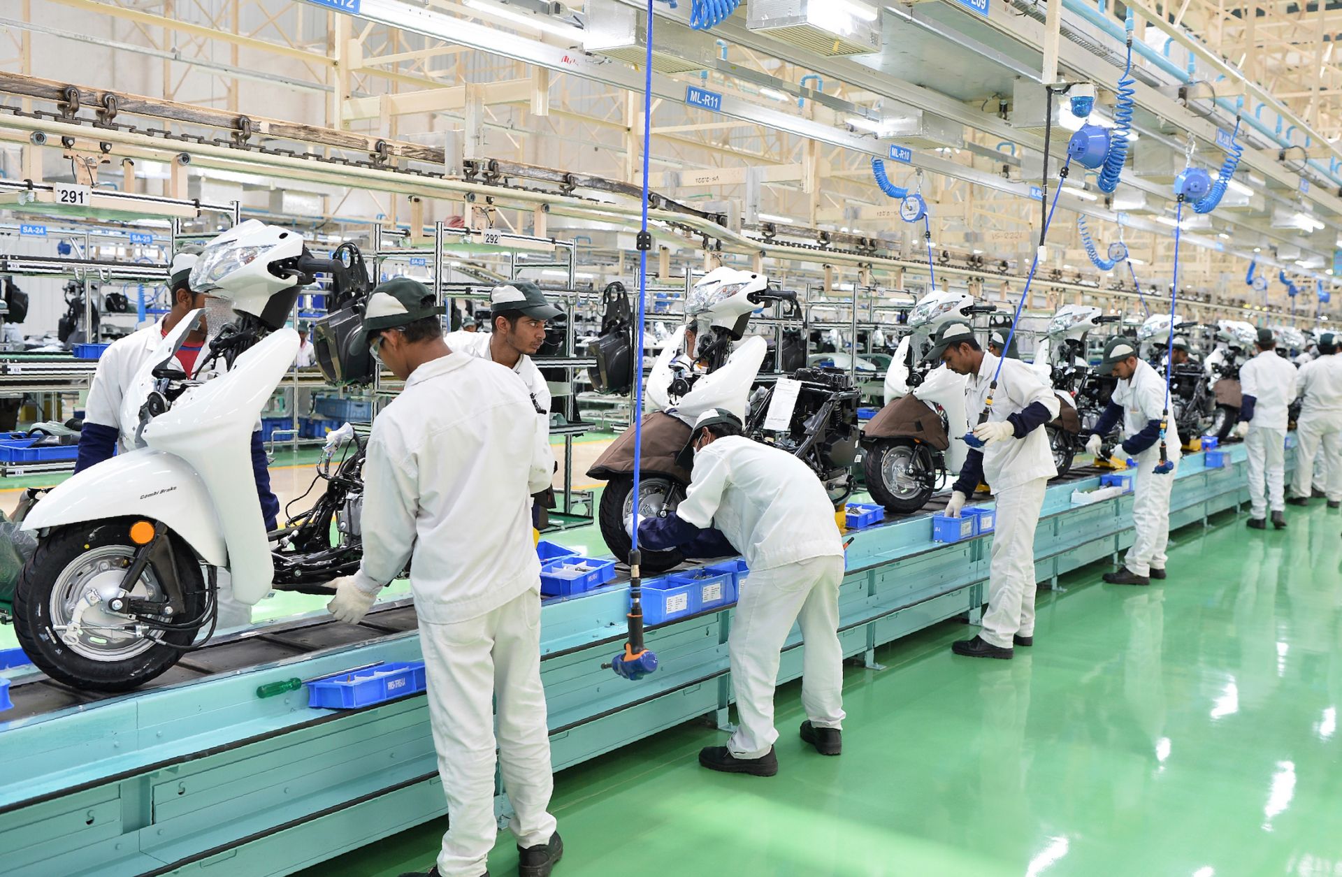 Employees assemble parts and make final inspections of Honda Activa scooters in Narasapura, on the outskirts of Bangalore, India. 