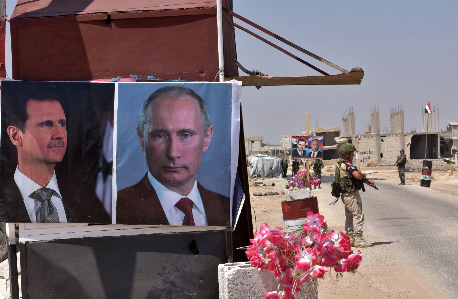 Posters of Syrian President Bashar al Assad and of Russian President Vladimir Putin adorn a kiosk at a border crossing in eastern Idlib province.