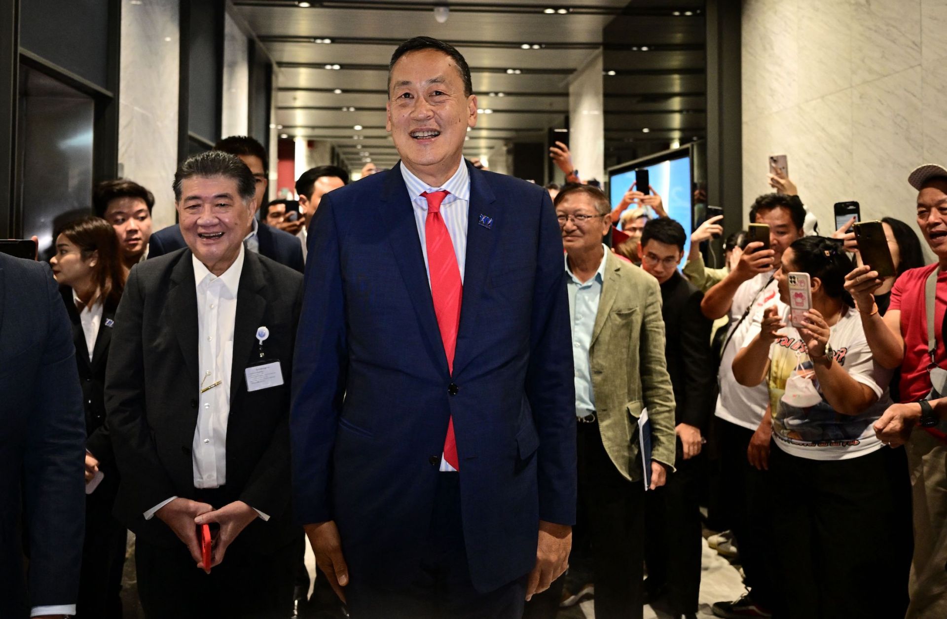 Thailand's newly appointed prime minister, Srettha Thavisin (center), greets supporters at his Pheu Thai Party's headquarters in Bangkok on Aug. 22, 2023.