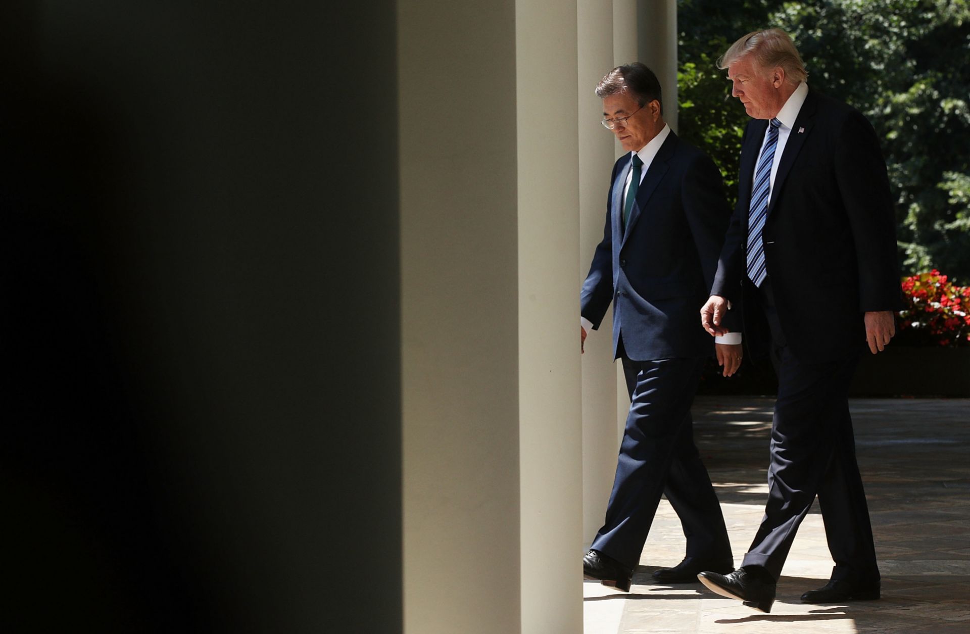 South Korean President Moon Jae In walks beside U.S. President Donald Trump at the White House in June 2017.