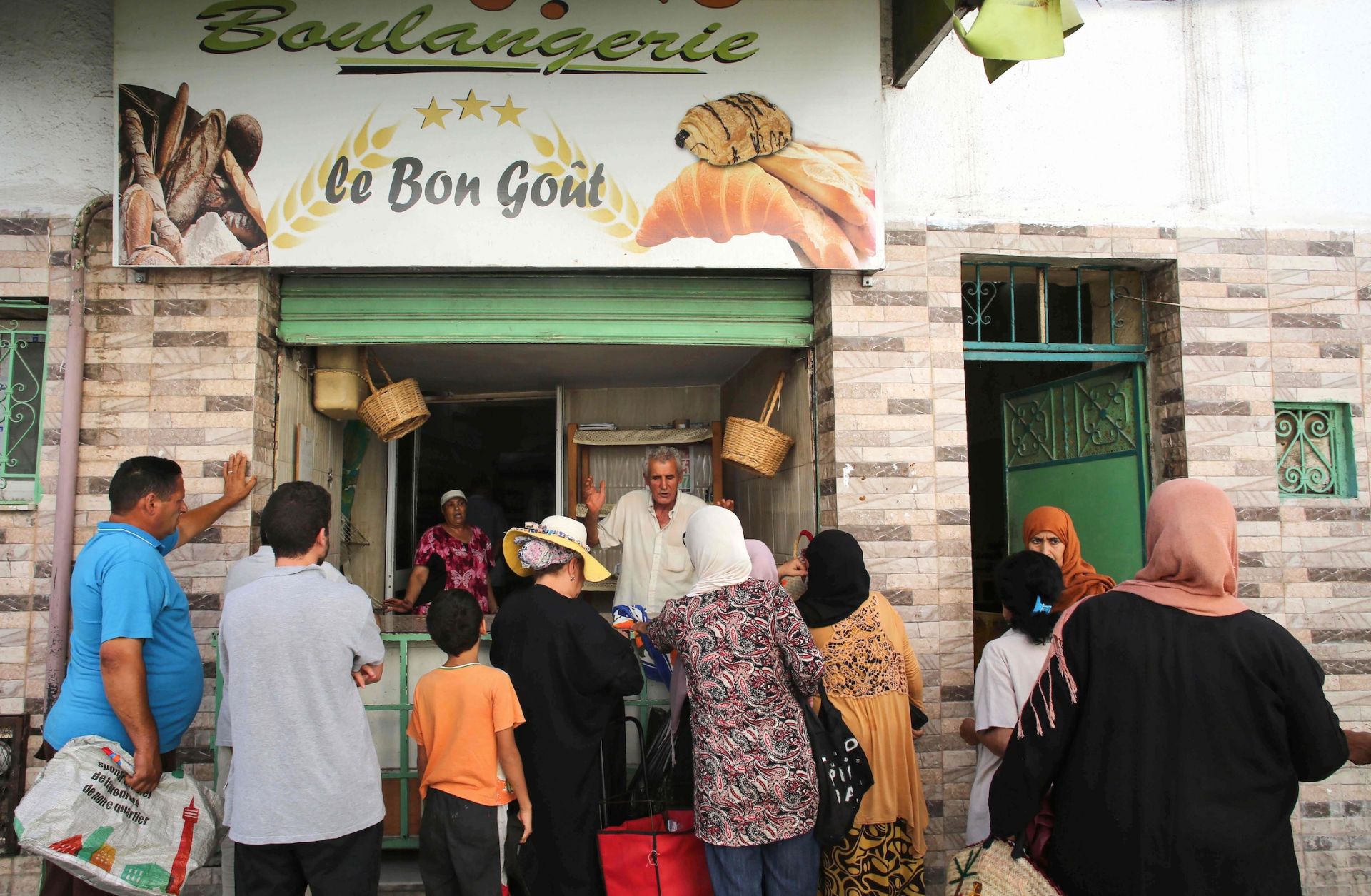 People line up in front of a bakery selling subsidized bread in Tunis, Tunisia, on Aug. 19, 2023.
