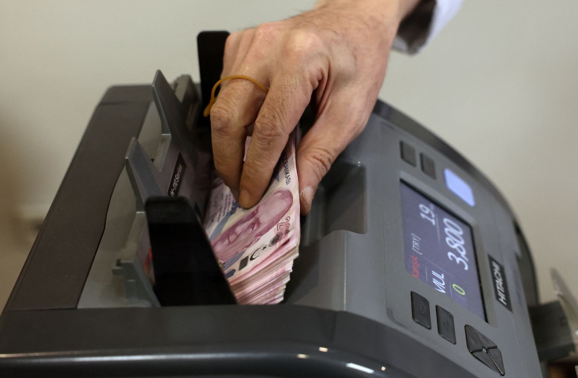 A teller uses a machine to count Turkish lira banknotes at a foreign exchange office in Ankara, Turkey, on July 20, 2023.