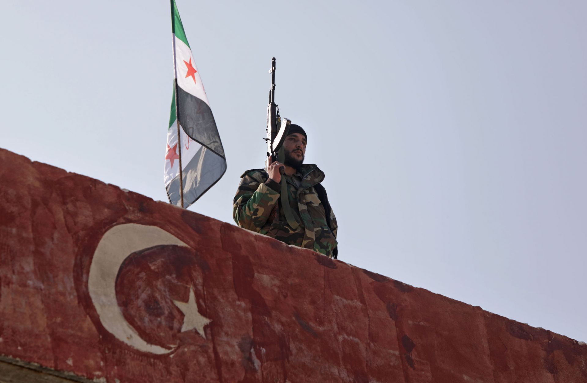 A Turkish-backed fighter guards the rebel-held province of Aleppo in northern Syria on Nov. 17, 2020.