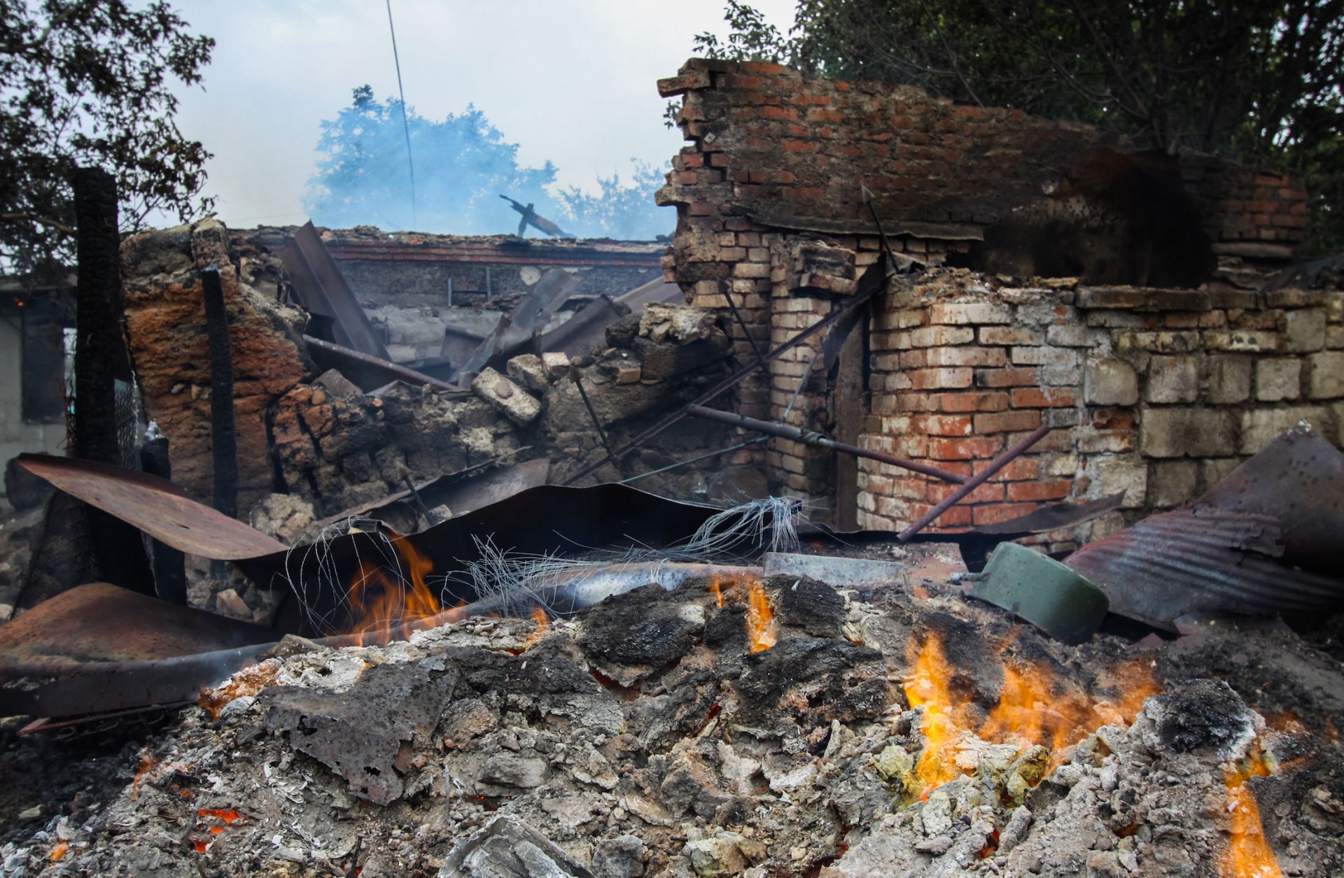 A house in the village of Roza in eastern Ukraine is left burning after fighting between Ukrainian forces and Russian separatists on Sept. 6, 2019.