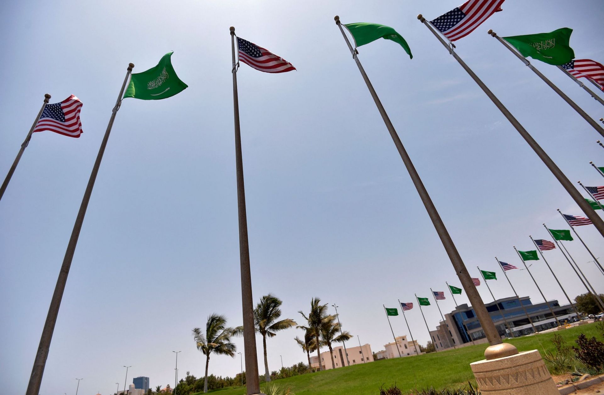 Saudi and U.S. flags line the King Abdulaziz Road in the Saudi Red Sea port city of Jeddah on July 14, 2022. 