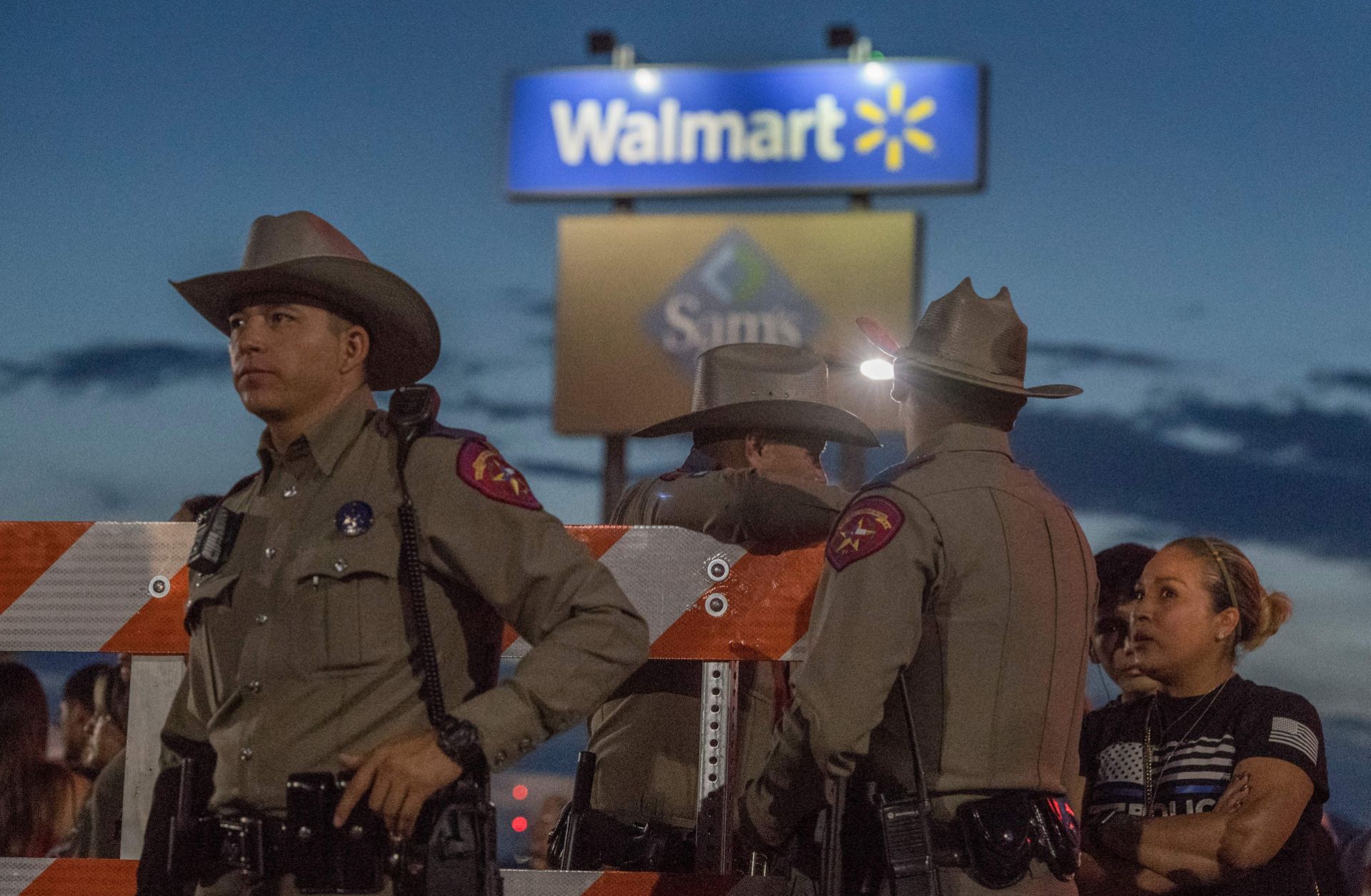 Texas State Troopers keep watch at the makeshift memorial for victims of the shooting that left a total of 22 people dead at the Cielo Vista Mall WalMart in El Paso, Texas, on August 6, 2019.