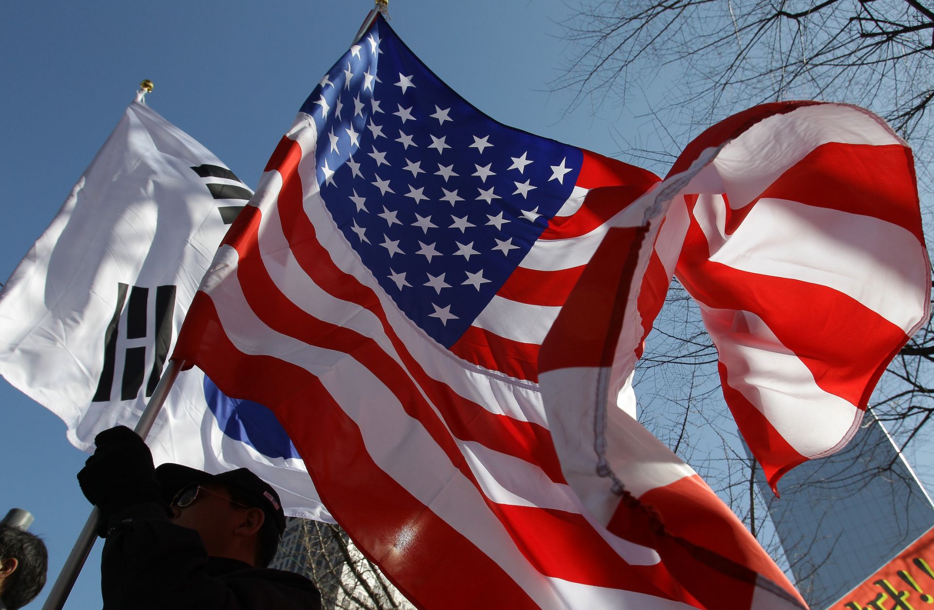 U.S. and South Korean flags are waved March 10, 2015, in Seoul, South Korea.
