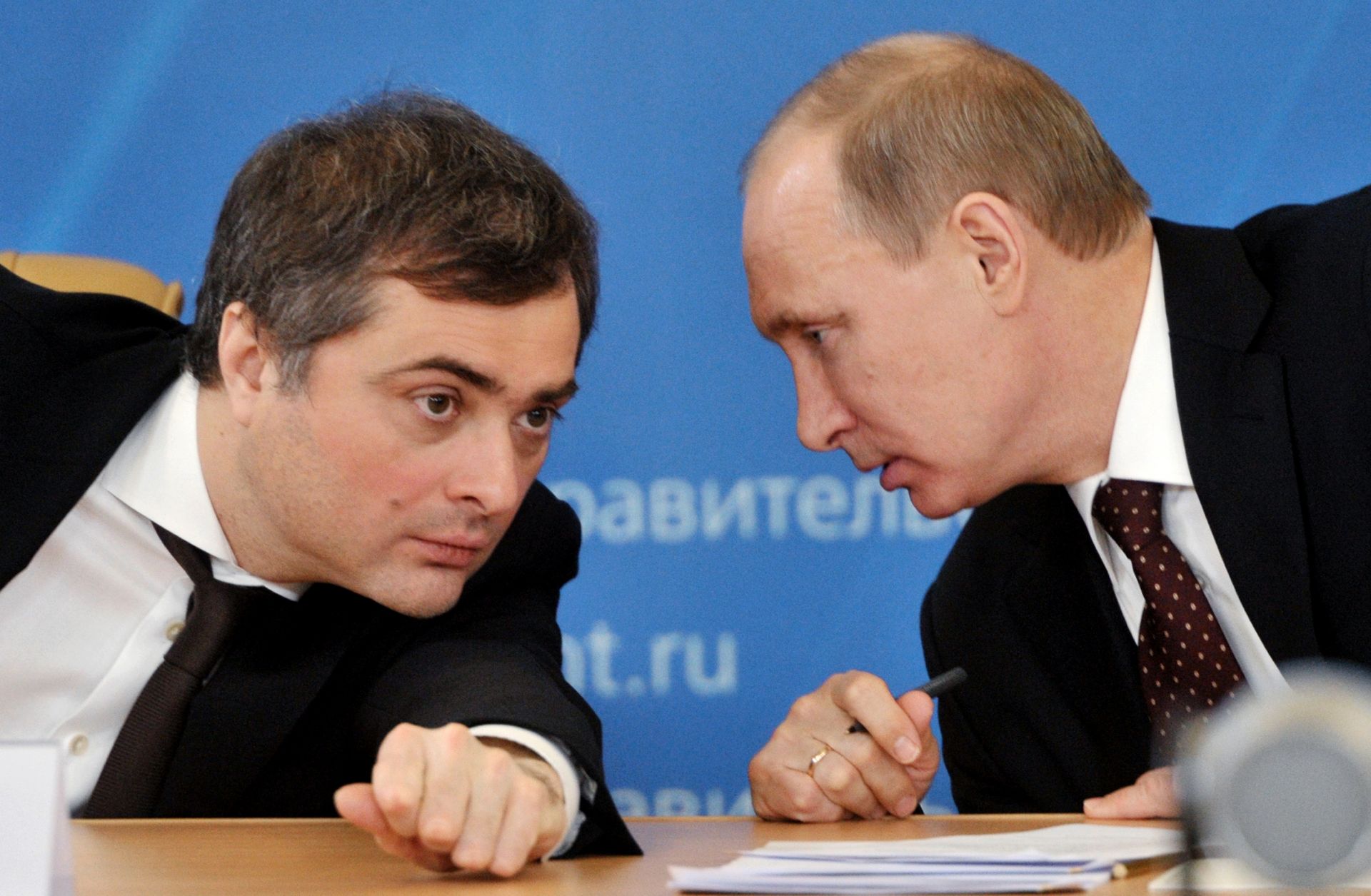 Russia's Prime Minister Vladimir Putin confers with his deputy Vladislav Surkov.