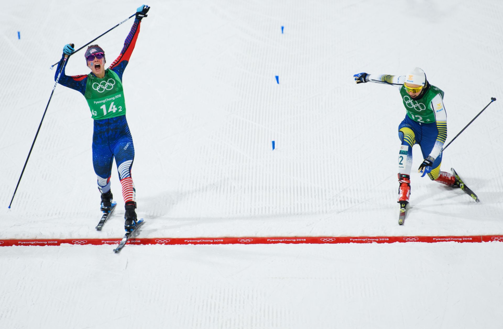 U.S. cross-country skier Jessica Diggins (L) crosses the finish line ahead of Swedish skier Stina Nilsson to win gold in the sprint event at the Winter Olympics in Pyeongchang, South Korea.
