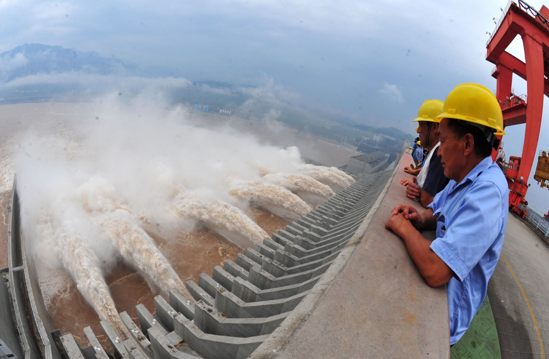 Workers watch in 2012 as water is released from the Three Gorges Dam, a gigantic hydropower project on the Yangtze River in central China.