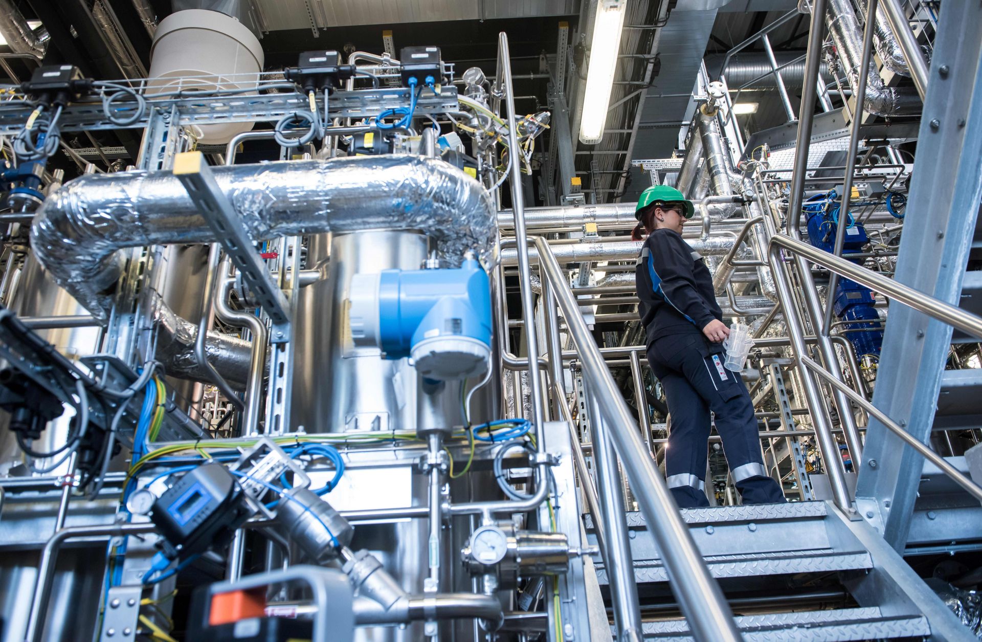 Biotechnology engineer Jenny Pietzsch walks through a demo plant of the French company Global Bioenergies during its inauguration ceremony in Leuna, Germany, on May 11, 2017.